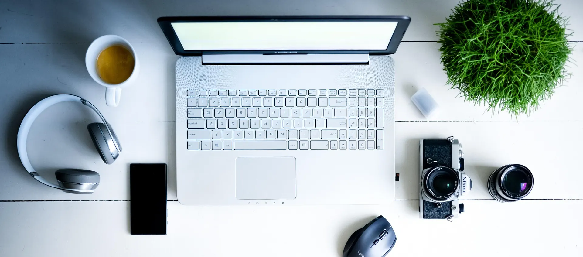 A Laptop and other electronic gadgets surrounding it